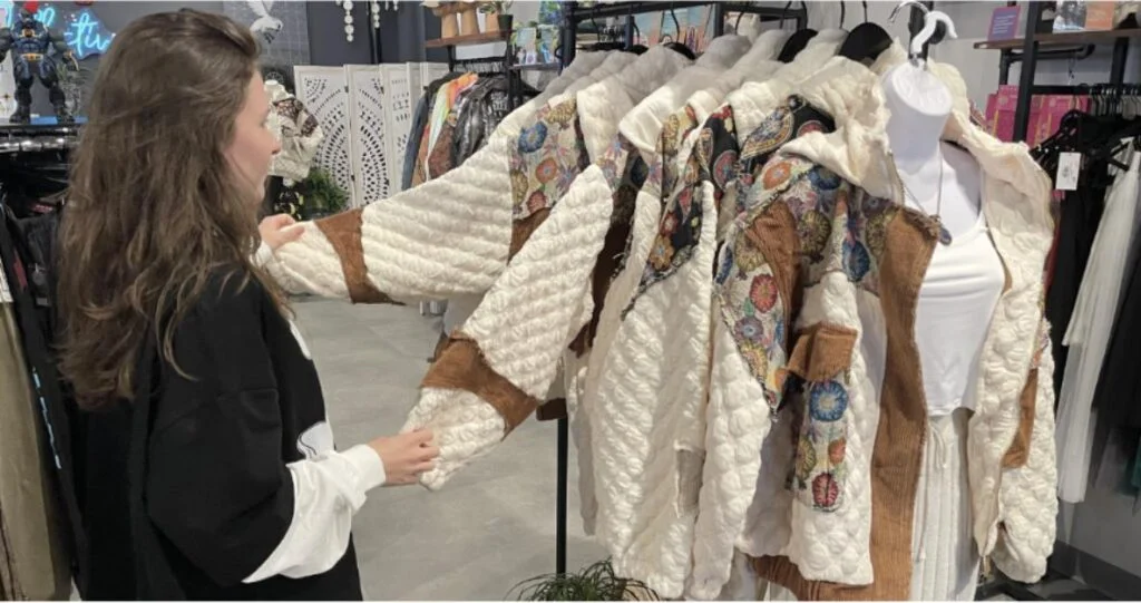 Shopper browsing fall clothing in a Portsmouth boutique