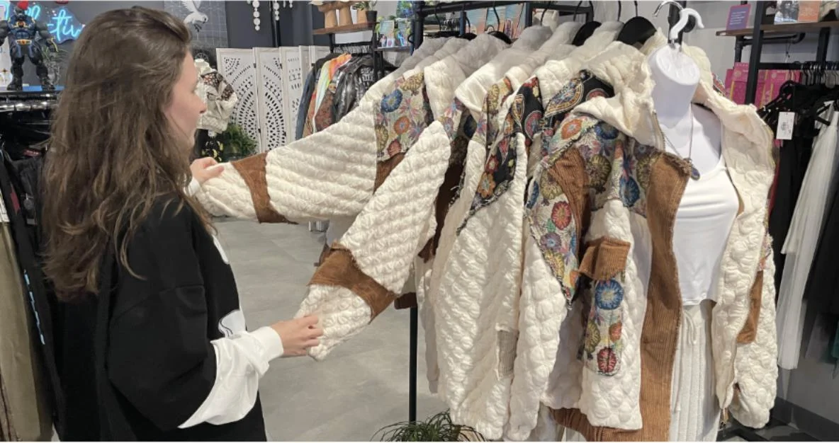 Shopper browsing fall clothing in a Portsmouth boutique
