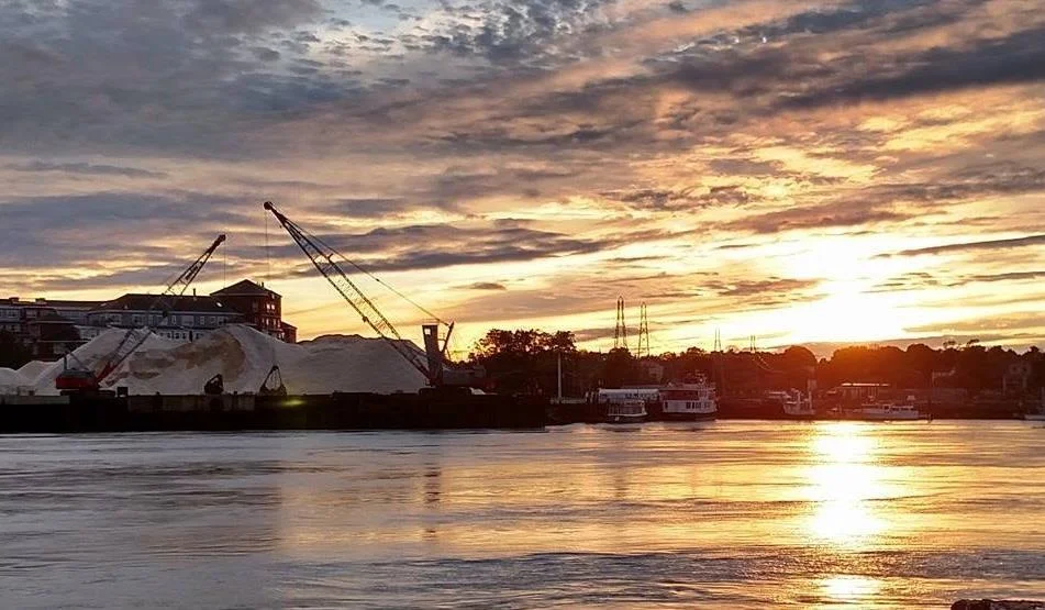 Portsmouth working waterfront and road salt piles at sunset